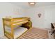 A cozy ' bedroom with a bunk bed, neutral decor, and a light-colored rug at 1307 Peregrine Ln, Greenwood, IN 46143