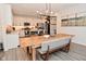 Open-concept dining room and kitchen featuring a rustic dining table and stylish lighting at 1307 Peregrine Ln, Greenwood, IN 46143