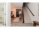 Open entryway flows into a cozy living room with a staircase leading to the upper level at 1307 Peregrine Ln, Greenwood, IN 46143