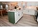 Spacious kitchen with white cabinets, green island, and stainless steel appliances at 1307 Peregrine Ln, Greenwood, IN 46143