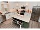 Bright kitchen featuring white cabinets, stainless steel appliances, and a large island at 1307 Peregrine Ln, Greenwood, IN 46143