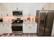 Modern kitchen with white cabinets, stainless steel appliances, and light countertops at 1307 Peregrine Ln, Greenwood, IN 46143