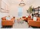 Bright living room featuring leather sofa and chairs, round coffee table, and large window with modern light fixture at 1307 Peregrine Ln, Greenwood, IN 46143