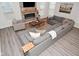 Open-concept living room features a comfortable sectional sofa, modern fireplace, and plenty of natural light at 1307 Peregrine Ln, Greenwood, IN 46143