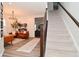 Bright living room features stylish furniture, modern chandelier, and staircase access to the upper level at 1307 Peregrine Ln, Greenwood, IN 46143