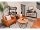 Bright living room with wood floors, leather chairs, and stylish decor, creating a cozy atmosphere at 1307 Peregrine Ln, Greenwood, IN 46143