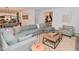 Spacious living room with a large sectional, plush ottoman, and a mix of textures and patterns creating an inviting space at 1307 Peregrine Ln, Greenwood, IN 46143