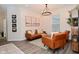Inviting living room features stylish leather seating, modern chandelier, and neutral decor creating a cozy ambiance at 1307 Peregrine Ln, Greenwood, IN 46143
