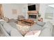 Modern living room with fireplace, TV, and sectional providing a comfortable and stylish gathering space at 1307 Peregrine Ln, Greenwood, IN 46143