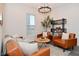 Cozy living room features leather seating, a stylish round coffee table, and shelving with modern decor at 1307 Peregrine Ln, Greenwood, IN 46143
