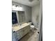Well-lit bathroom with a single vanity, a large mirror, and tile flooring at 1347 Preserve Ct, Greenwood, IN 46143