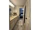 Well-lit bathroom with double vanity sinks, a decorative rug, and a view into the bedroom at 1347 Preserve Ct, Greenwood, IN 46143