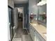 Well-lit bathroom featuring dual sinks, neutral tile, and access to a closet at 1347 Preserve Ct, Greenwood, IN 46143
