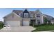 Beautiful two-story home with a brick facade, two-car garage, and well-manicured lawn at 1347 Preserve Ct, Greenwood, IN 46143