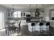 Bright kitchen with white cabinets, stainless steel appliances, a large island, and an adjacent dining area at 1347 Preserve Ct, Greenwood, IN 46143