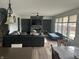 Spacious living room featuring a large sectional sofa, stone fireplace, and plenty of natural light from large windows at 1347 Preserve Ct, Greenwood, IN 46143
