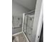 Shower with glass doors and a neutral colored shower curtain rod, providing a practical and clean space at 1347 Preserve Ct, Greenwood, IN 46143