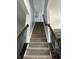 Carpeted staircase with wooden handrails and wrought iron balusters at 1347 Preserve Ct, Greenwood, IN 46143