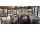 Bright sunroom with vaulted ceilings, expansive windows, stylish furniture, and cozy decor at 13522 Spring Farms Dr, Carmel, IN 46032