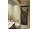 Bathroom with shower stall with decorative door and adjacent toilet and vanity at 1437 E Pleasant Run Pkwy S Dr, Indianapolis, IN 46203