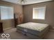 Bedroom featuring natural light from two windows and a built-in closet at 1437 E Pleasant Run Pkwy S Dr, Indianapolis, IN 46203