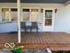 Inviting covered porch with seating, creating a cozy and welcoming entrance to the home at 1437 E Pleasant Run Pkwy S Dr, Indianapolis, IN 46203