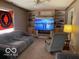 Inviting living room showcasing built-in shelving, fireplace with mounted TV, and cozy seating area with natural light at 1437 E Pleasant Run Pkwy S Dr, Indianapolis, IN 46203