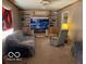 Cozy living room featuring built-in shelving, a fireplace with mounted TV, and comfortable seating with neutral tones at 1437 E Pleasant Run Pkwy S Dr, Indianapolis, IN 46203
