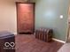 Room featuring hardwood floors, a corner cabinet, and vintage trunk offering a classic design element at 1437 E Pleasant Run Pkwy S Dr, Indianapolis, IN 46203