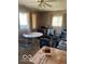 Cluttered room with a ceiling fan, windows, and a round table that could be transformed into a functional space at 1437 E Pleasant Run Pkwy S Dr, Indianapolis, IN 46203
