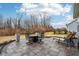 Large outdoor patio with seating, fireplace and views of landscaped backyard at 14904 Tiago Ln, Fishers, IN 46040