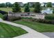 A landscaped entrance sign for Mill Ridge Farms with a pond and fountain feature in the background at 14904 Tiago Ln, Fishers, IN 46040
