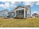 A spacious yard featuring a screened in porch with outdoor furniture surrounded by mature landscaping at 14904 Tiago Ln, Fishers, IN 46040