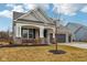 Beautiful single-Gathering home with brick accents, dormer windows, and a covered front porch at 14904 Tiago Ln, Fishers, IN 46040