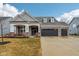 Charming single-Gathering home with brick accents, a three-car garage, and a welcoming front porch at 14904 Tiago Ln, Fishers, IN 46040