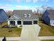 Beautiful aerial view of home with a three-car garage, nice landscaping, and inviting front porch at 14904 Tiago Ln, Fishers, IN 46040