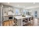 Bright, modern kitchen with stainless steel appliances, a large center island, and barstool seating at 14904 Tiago Ln, Fishers, IN 46040