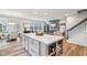 Spacious open-concept with a large island, modern appliances, and a cozy living area at 14904 Tiago Ln, Fishers, IN 46040