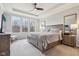 Bright main bedroom with a tray ceiling, plush carpet, and large windows at 14904 Tiago Ln, Fishers, IN 46040