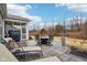 Relaxing patio area featuring a grill, lounge chairs, and an outdoor dining set for enjoying the backyard at 14904 Tiago Ln, Fishers, IN 46040