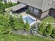 Aerial view of the pool, patio area, and outdoor living space in a landscaped backyard at 15694 Provincial Ln, Fishers, IN 46040