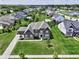 Aerial view of a well landscaped home in a community with mature trees, a playground, and a pond at 15694 Provincial Ln, Fishers, IN 46040