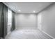 Unfinished basement area featuring neutral walls, plush carpet, and a door for potential customization at 15694 Provincial Ln, Fishers, IN 46040