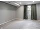 Neutral basement space features a window, plush carpeting and a modern, clean aesthetic at 15694 Provincial Ln, Fishers, IN 46040