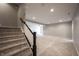 Basement staircase leading to open area with plush carpeting and neutral walls, perfect for recreation at 15694 Provincial Ln, Fishers, IN 46040