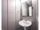 Small bathroom featuring a pedestal sink, mirror, towel ring, and beadboard paneling at 15694 Provincial Ln, Fishers, IN 46040