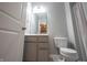 This half bathroom features a stylish vanity, a large mirror, and a white toilet at 15694 Provincial Ln, Fishers, IN 46040