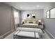 Bedroom with neutral colors, patterned bedding, bench, and natural light creates a comfortable and relaxing atmosphere at 15694 Provincial Ln, Fishers, IN 46040