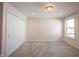 Bright bedroom featuring a closet, carpet, a stylish light fixture, and a sunny window at 15694 Provincial Ln, Fishers, IN 46040