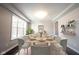 Formal dining area boasts modern furnishings and bright, natural light from large windows at 15694 Provincial Ln, Fishers, IN 46040